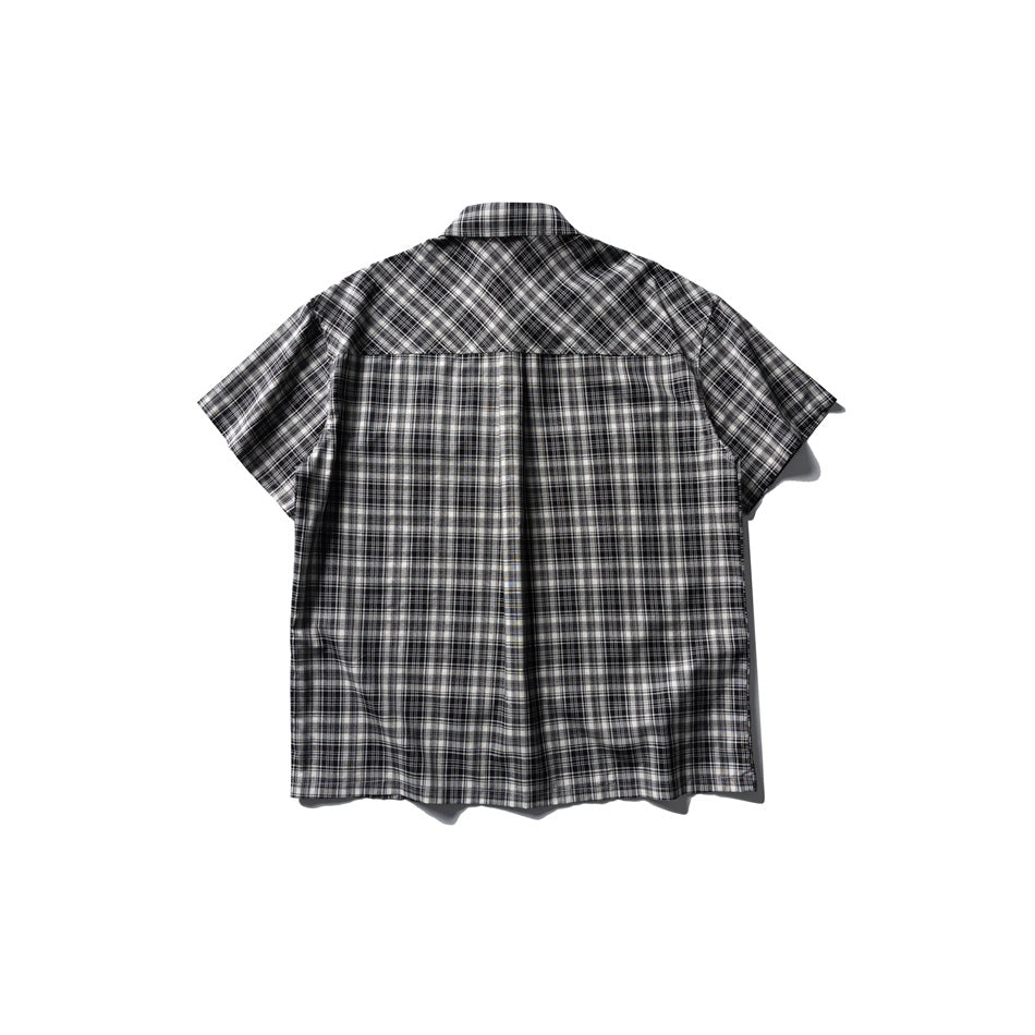 Back view of black and white plaid short-sleeve shirt with a diagonal plaid yoke, flat lay