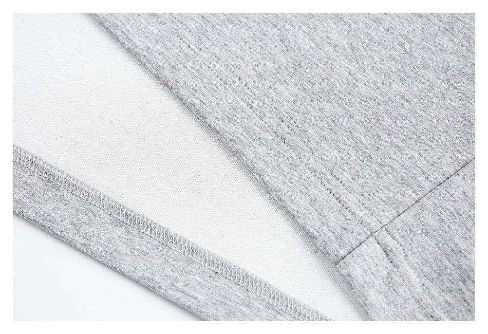 Close-up of the gray shirt's inside fabric and overlocked hem stitching.