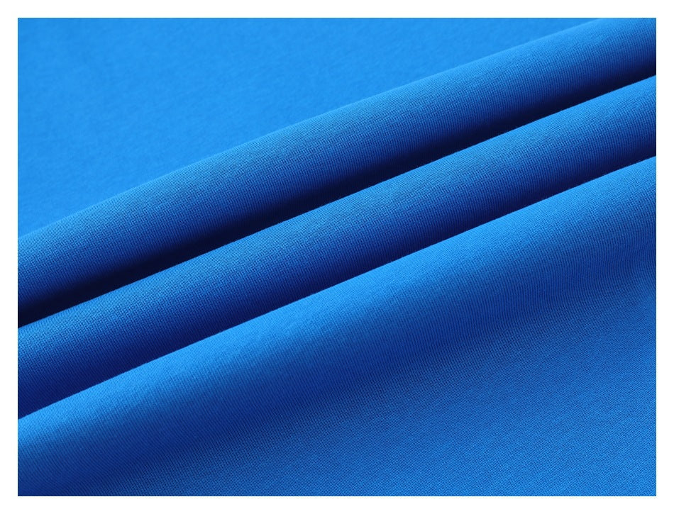 Macro view of bright blue fabric arranged in soft folds.
