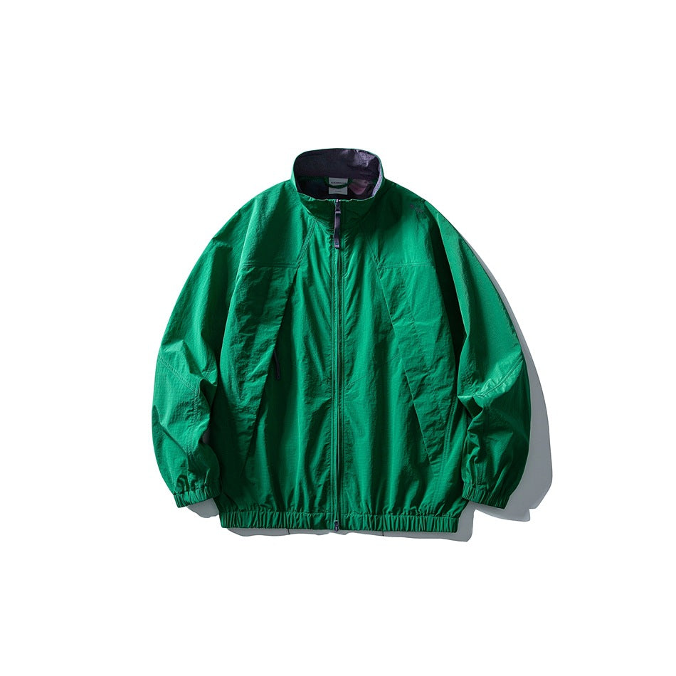 Forest green zip-up stand-collar jacket with dark inner collar and elastic cuffs and hem