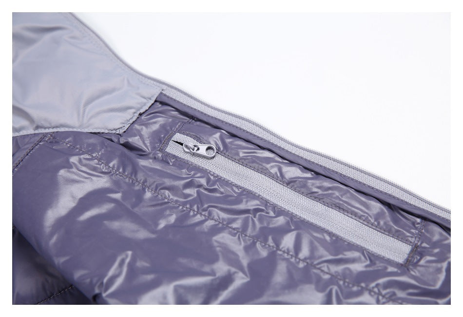 Close-up of a light gray zipper pocket on the shiny purple-gray jacket lining.