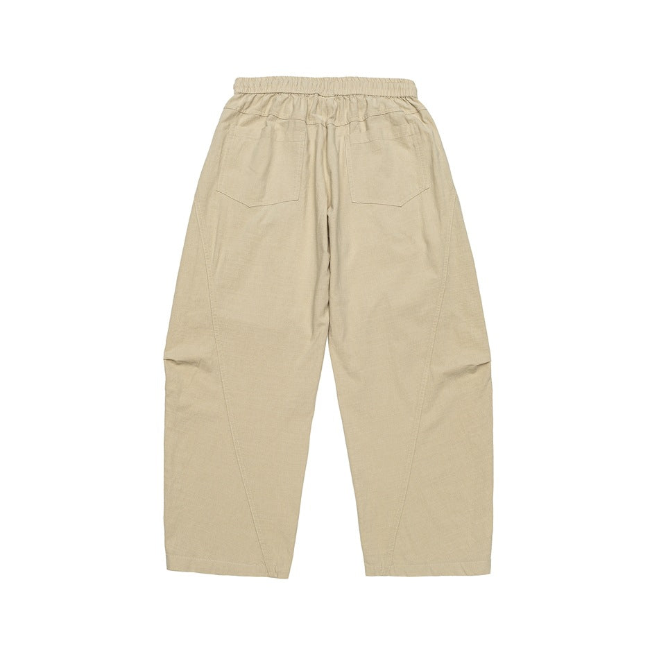 Light khaki wide-leg pants back view with elastic waistband, two patch pockets and curved leg seams