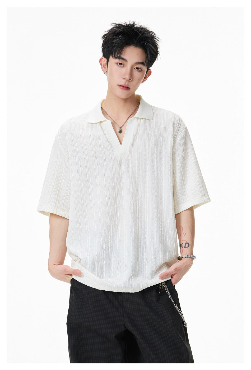 Model wearing an ivory short-sleeve polo with a collar, open placket, and vertical textured stripes.