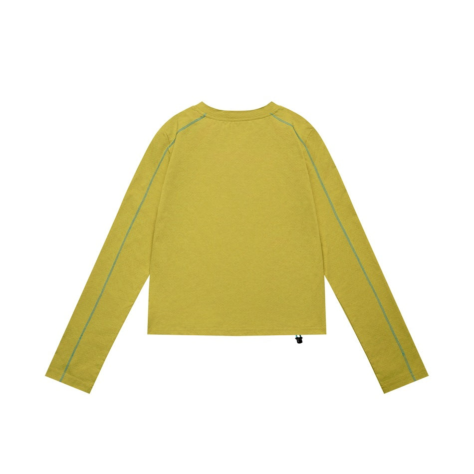 Back view of a mustard yellow long-sleeve top with teal raglan seam stitching and a small hem drawcord toggle.