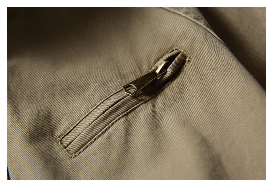 Close-up of a slanted zip pocket on khaki jacket fabric.