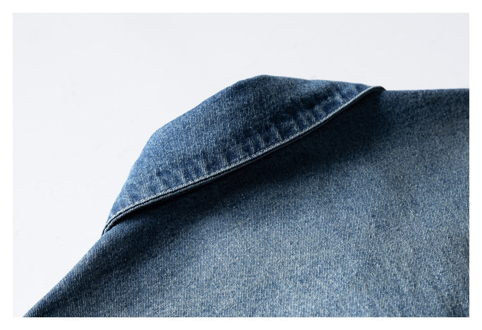 Close-up of the blue denim shirt collar folded over the shirt fabric.
