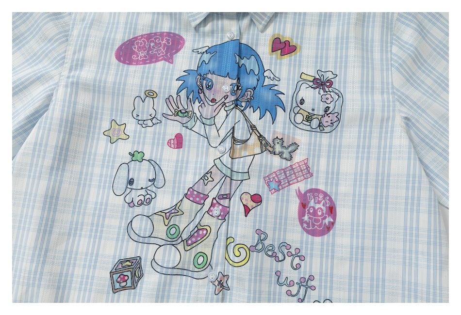 Close-up of a colorful blue-haired cartoon girl and playful doodles printed on a pale blue plaid shirt.