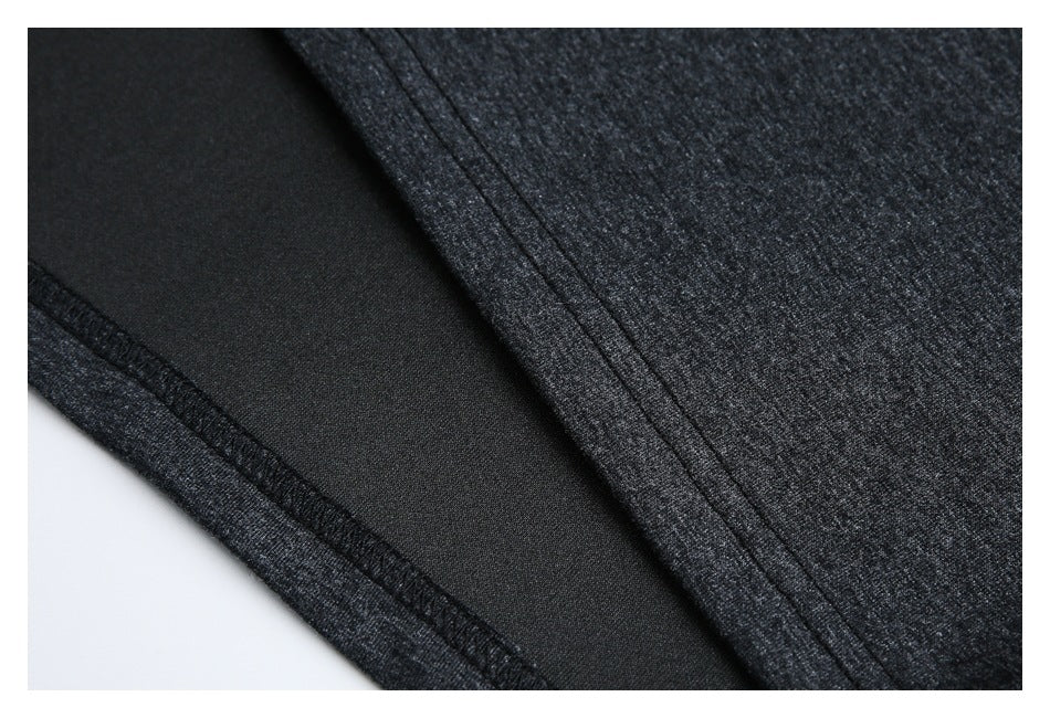 Close-up of the garment's dark inner side and overlocked seam beside charcoal heather fabric.