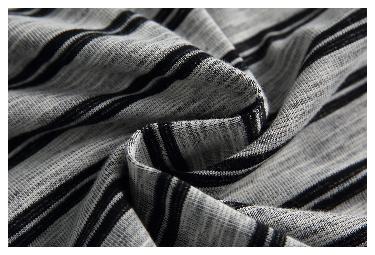 Close-up of draped gray knit fabric with narrow black stripes and visible knit texture.