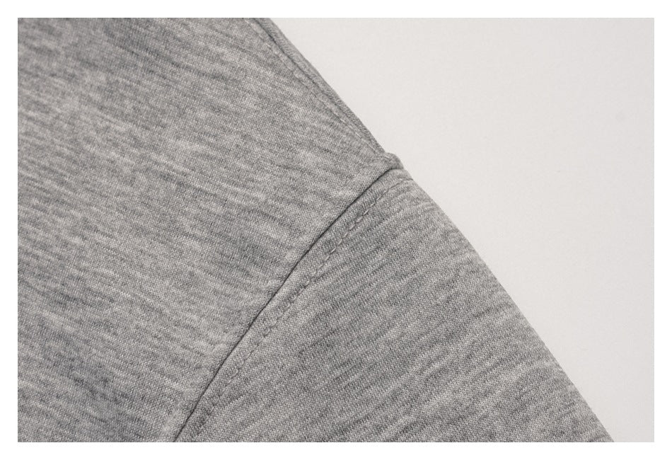 Close-up of the heather gray pullover's shoulder and sleeve seam.