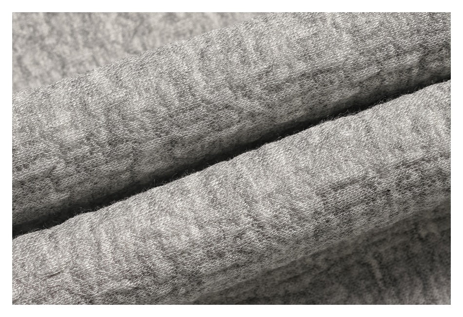 Close-up of folded light gray fabric showing its knit texture.