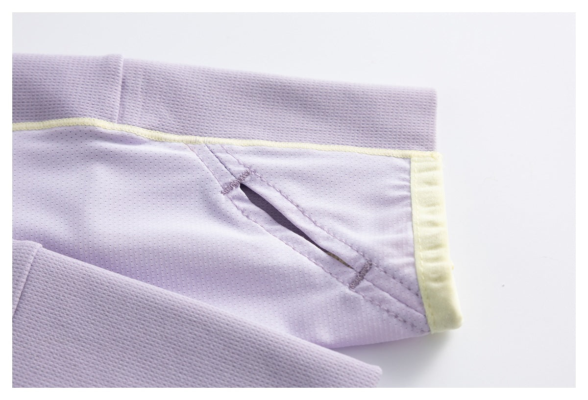 Close-up of lavender perforated fabric with pale yellow trim and a stitched opening.