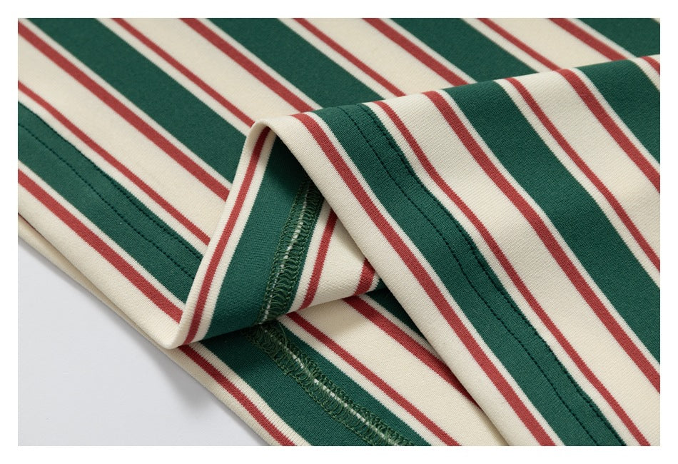 Close-up of striped fabric folded to show the garment's interior overlock seam and stitching.