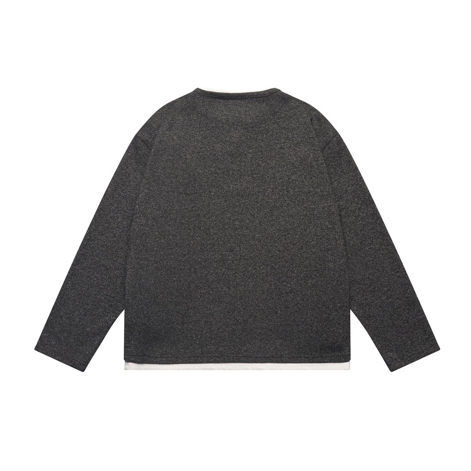 Back view of a charcoal marled long-sleeve top with a white layer peeking below the hem.