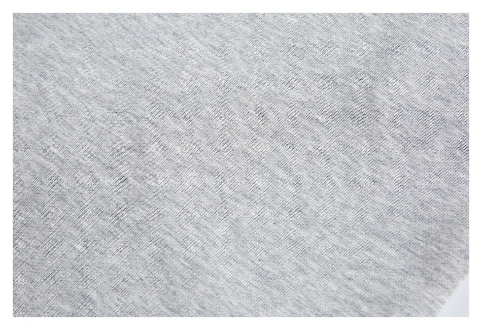 Close-up of the light gray garment's fine heathered knit surface.