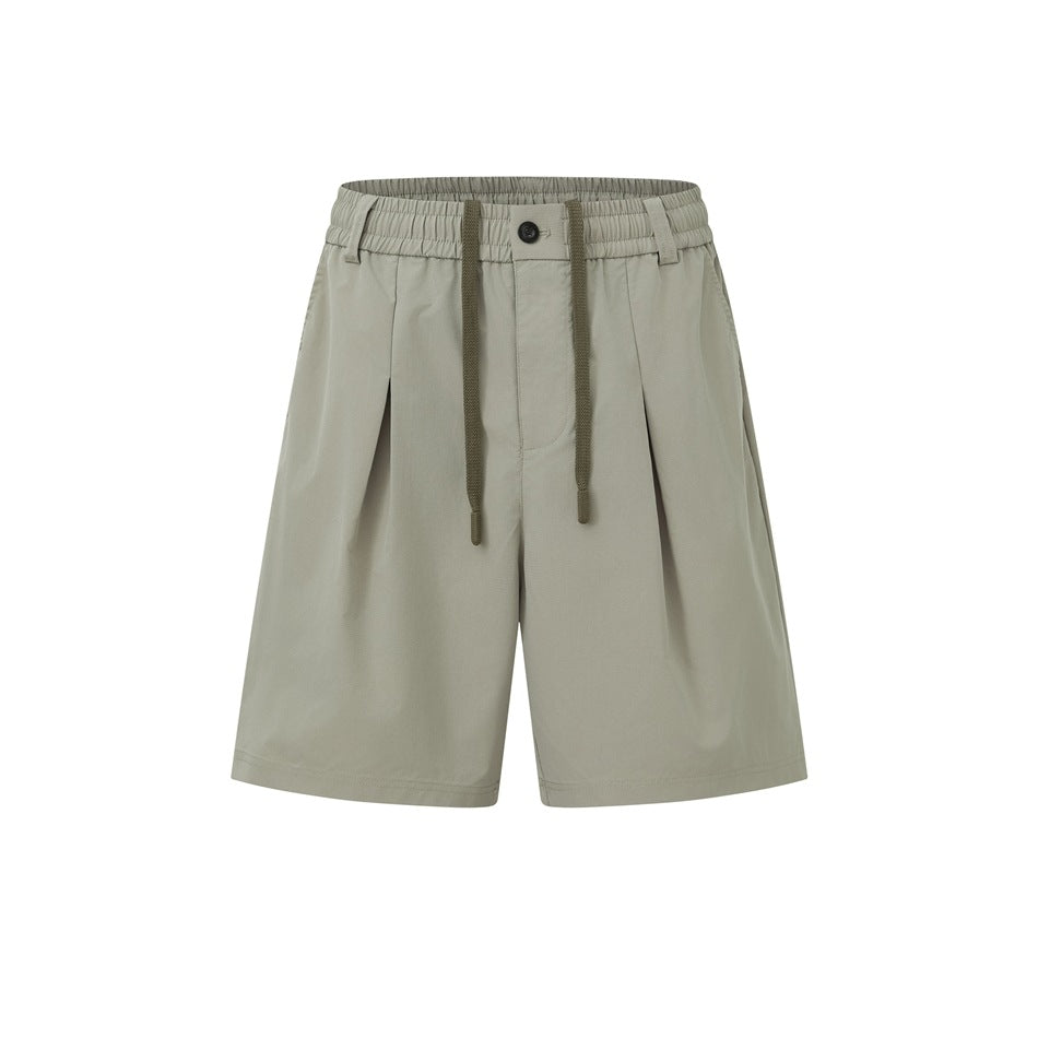 Gray-green pleated drawstring shorts with elastic waistband and button, flat front view on white background