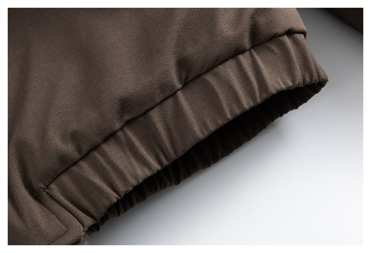 Close-up of the brown jacket's elasticized cuff with gathered fabric.