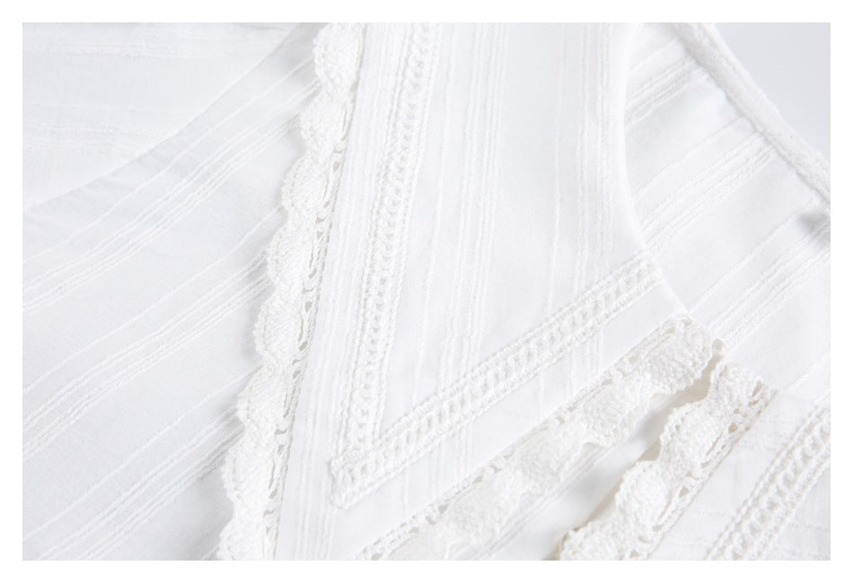 Close-up of a white shirt collar with layered scalloped lace and stitched trim.