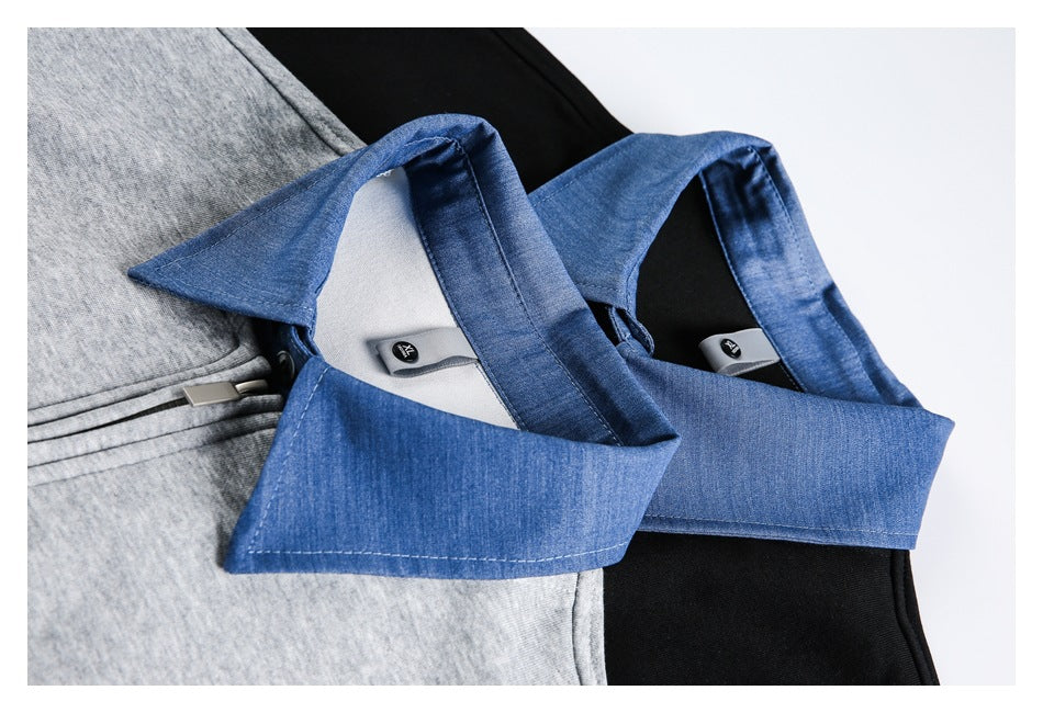 Close-up of a blue denim-style collar on a gray zip-up jacket, with black inner fabric visible.