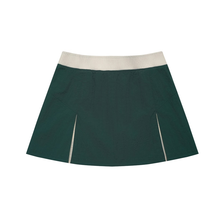 Dark green A-line mini skirt with beige ribbed waistband and front vent slits with cream inserts, flat lay