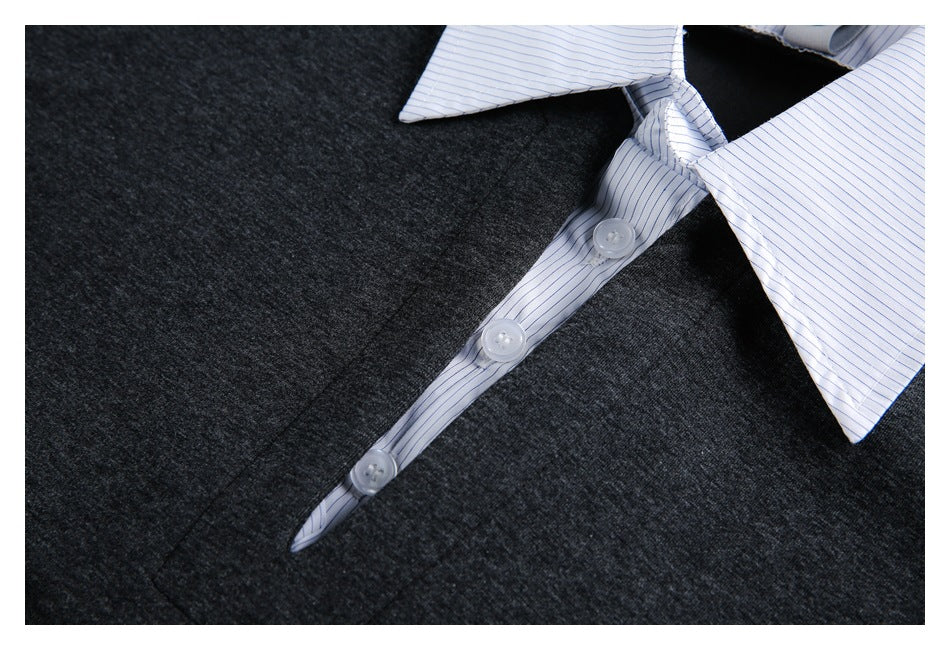 Close-up of a charcoal heather garment with a white pinstriped collar and matching button placket.