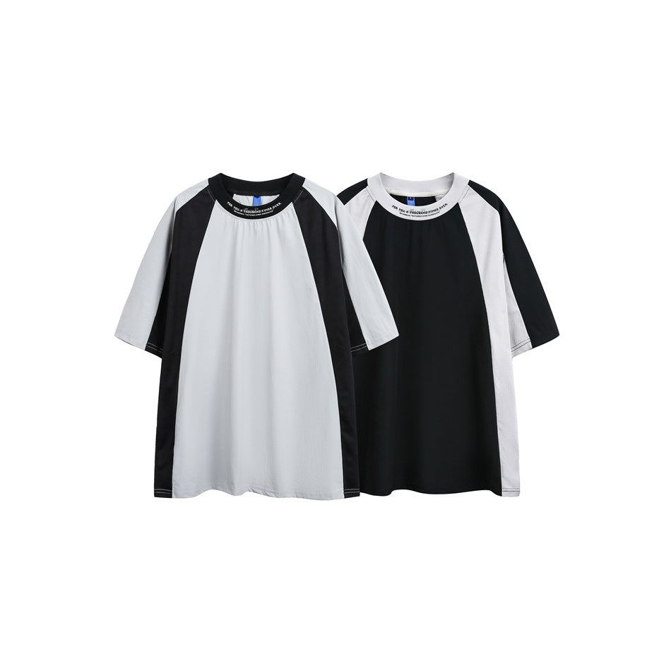 Front view of two short-sleeve raglan T-shirts: one light gray with black panels and one black with light gray panels.