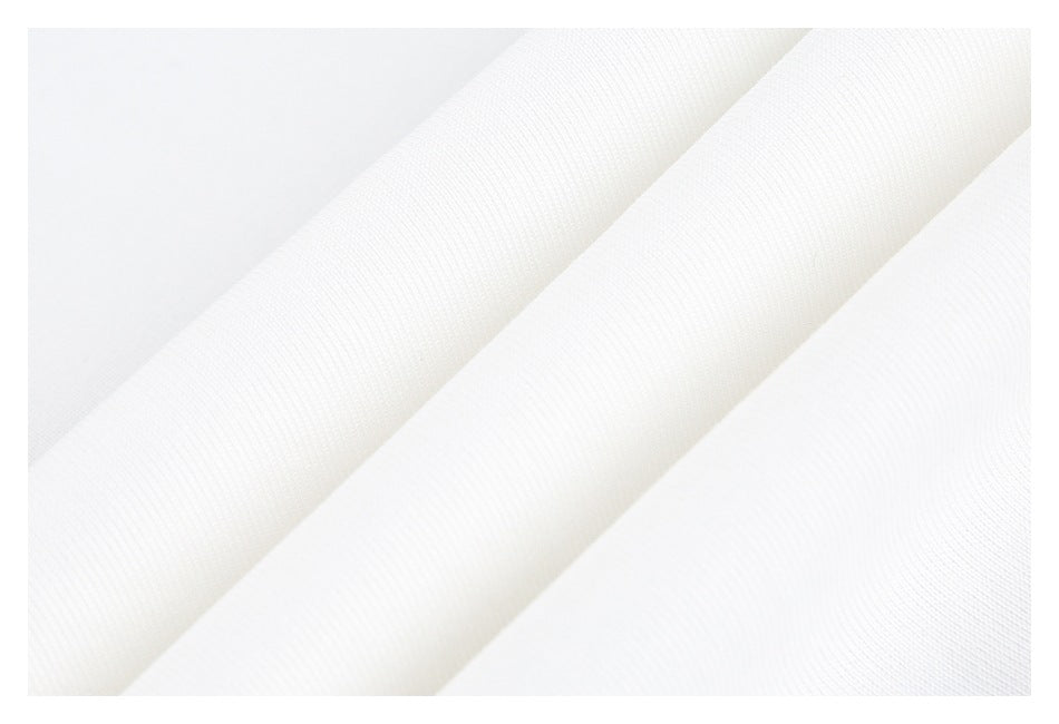 Close-up of folded white garment fabric showing its fine knit texture.