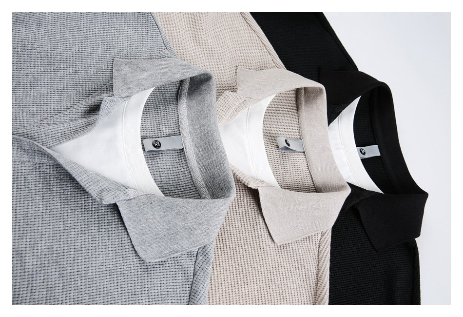 Three textured collared shirts in gray, beige, and black, arranged together with white inner plackets.