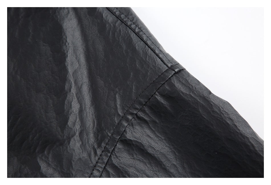 Close-up of the black textured shirt’s sleeve and stitched seam.