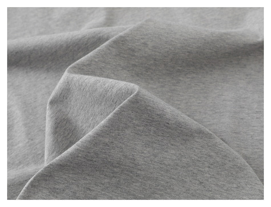 Close-up of heather-gray T-shirt fabric arranged in soft folds.