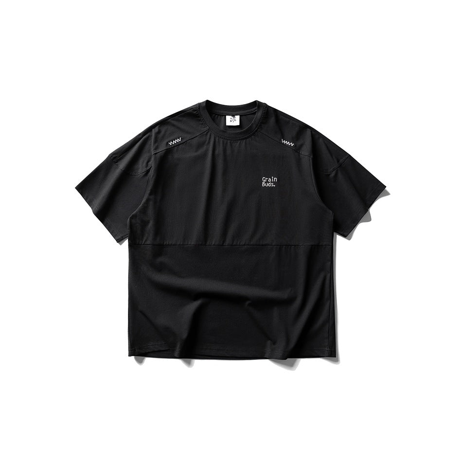 Black short-sleeve crew-neck T-shirt flat lay with shoulder zigzag stitching, lower seam and small chest embroidery