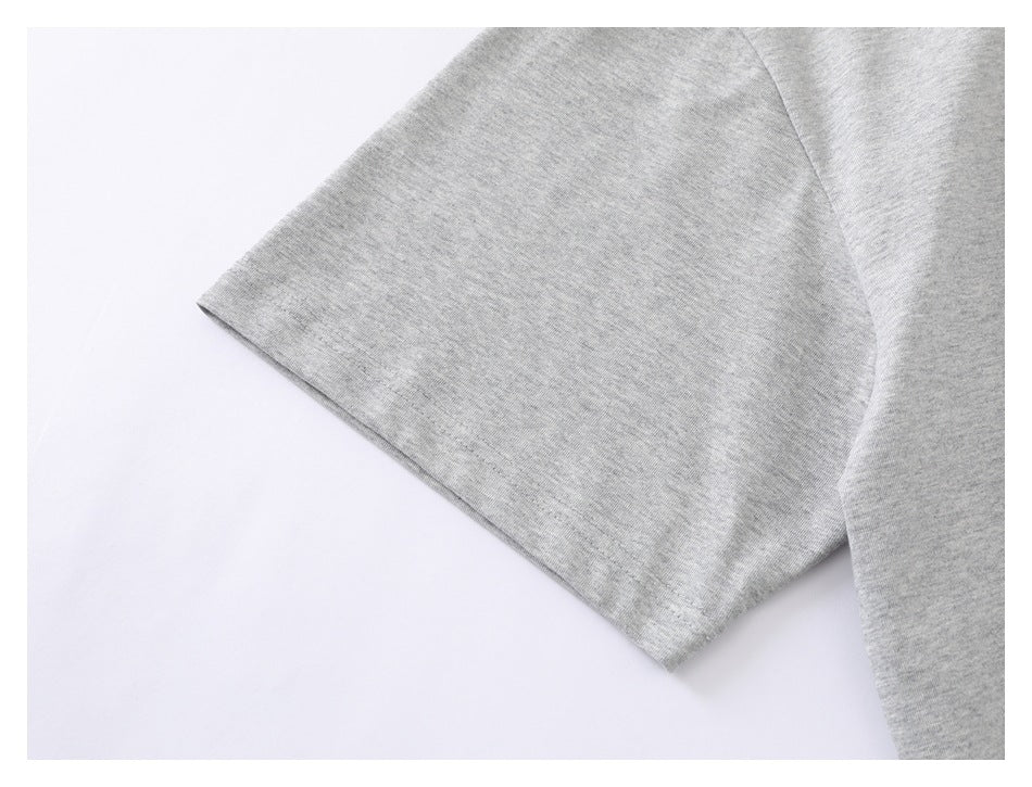 Close-up of the short sleeve and seam on a heather gray T-shirt.