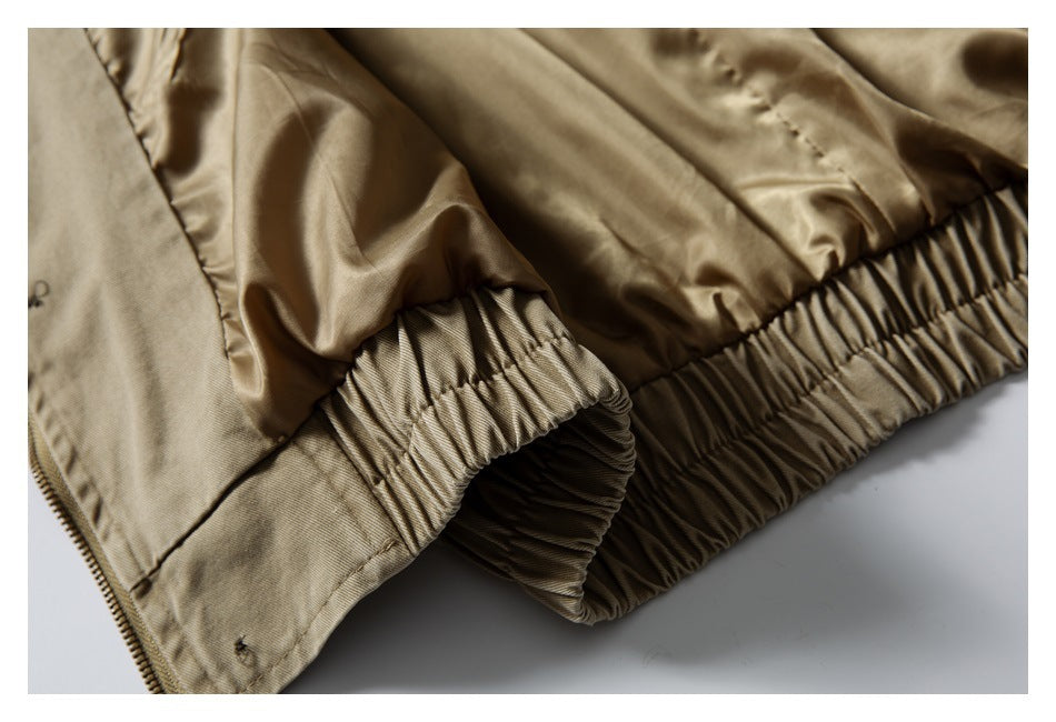Close-up of the khaki jacket's gathered elastic hem and inner lining.