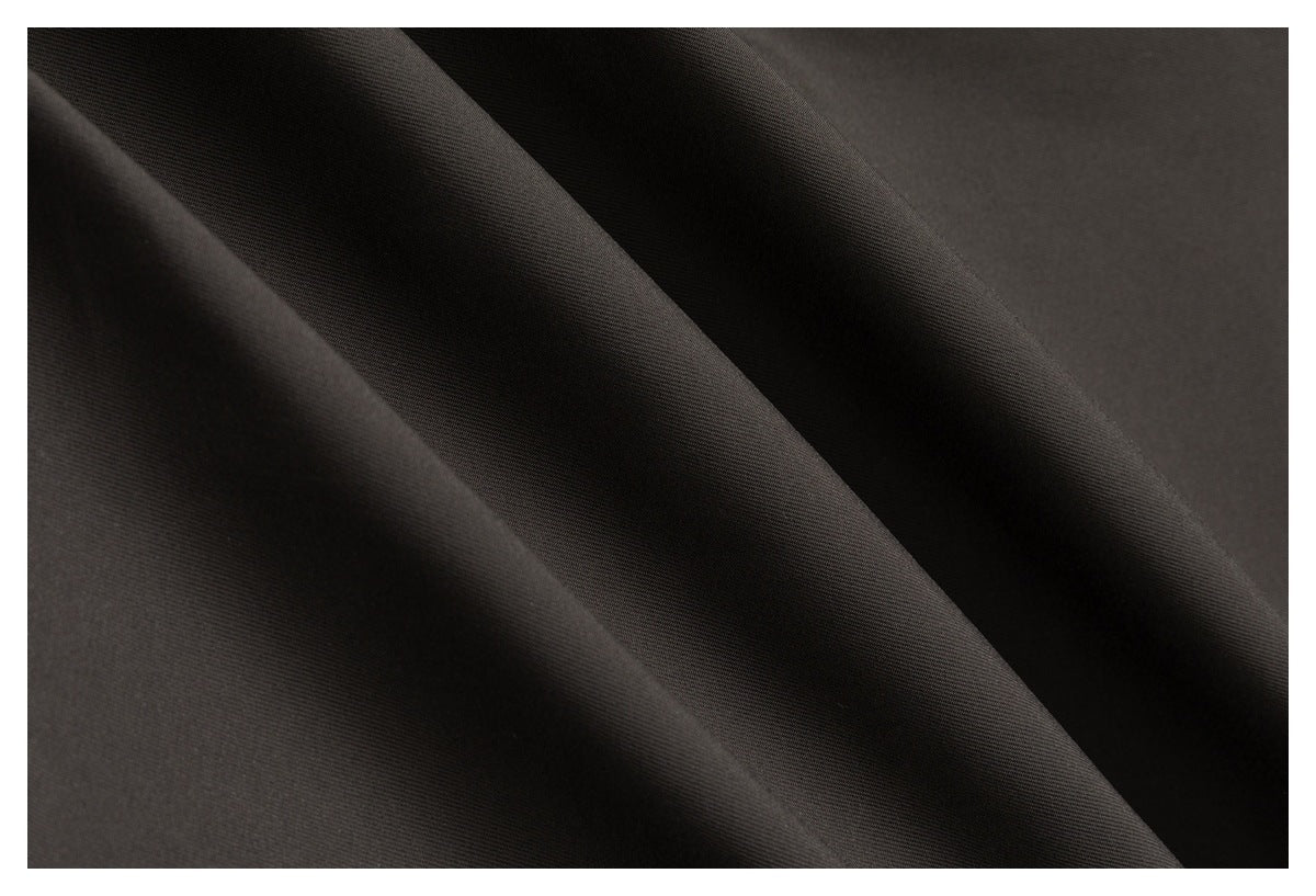 Close-up of dark charcoal-black fabric arranged in soft diagonal folds, showing a fine, smooth surface.