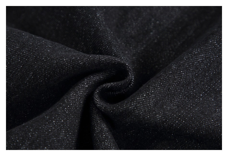 Close-up of black textured fabric gathered into soft folds.