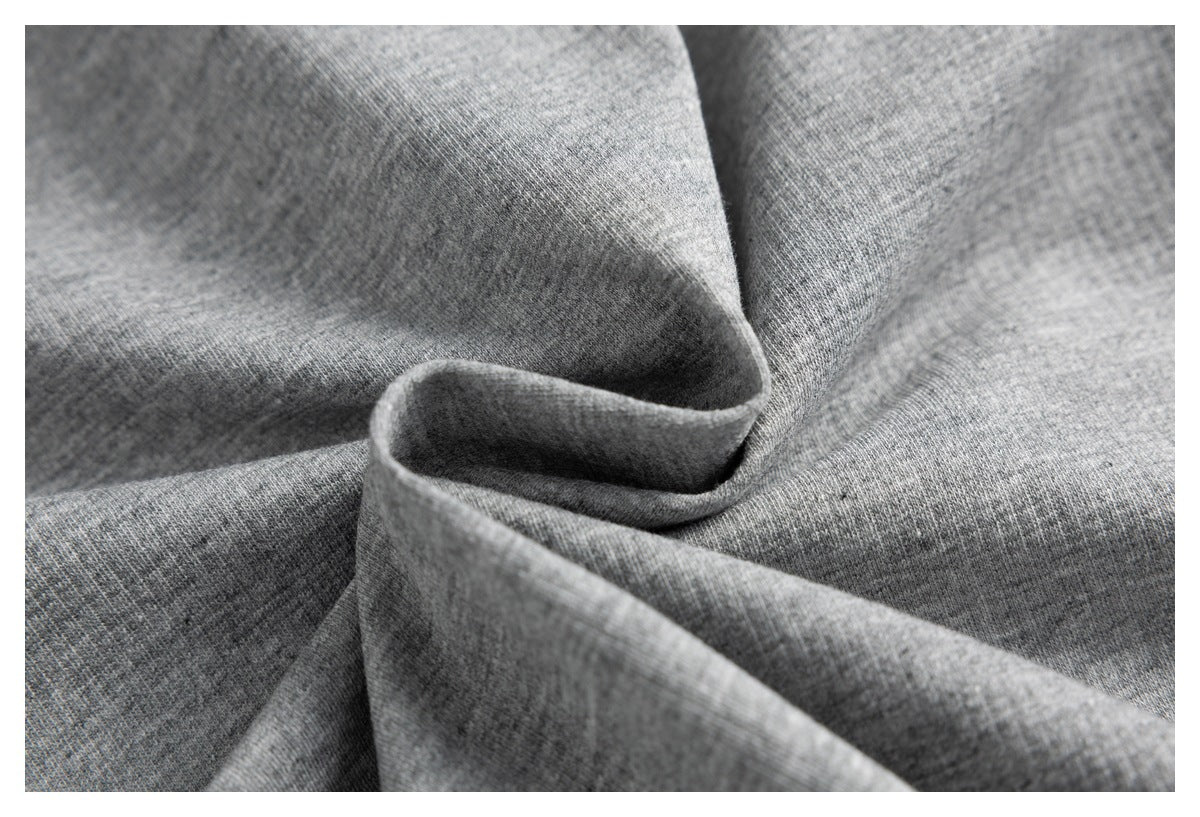 Close-up of heather gray fabric arranged in soft folds.