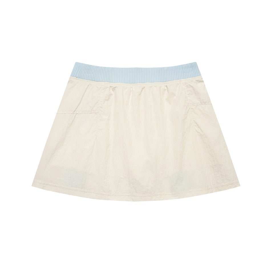 Back view of an ivory flared skirt with a wide pale blue ribbed waistband.