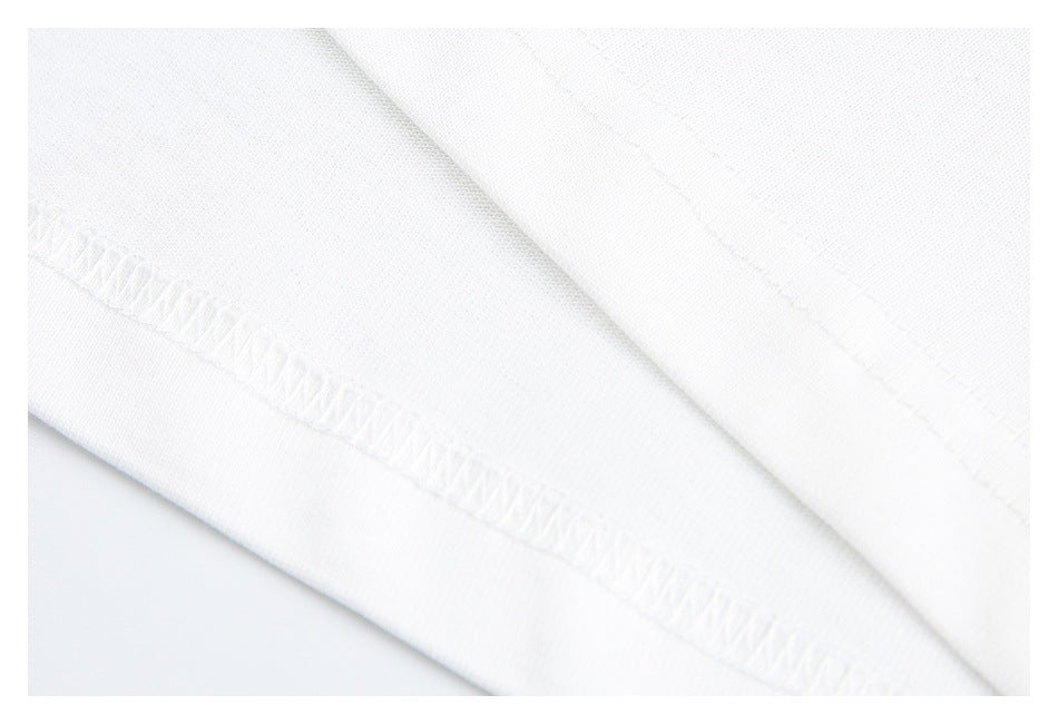 Close-up showing the white T-shirt's folded edge and overlock stitching.