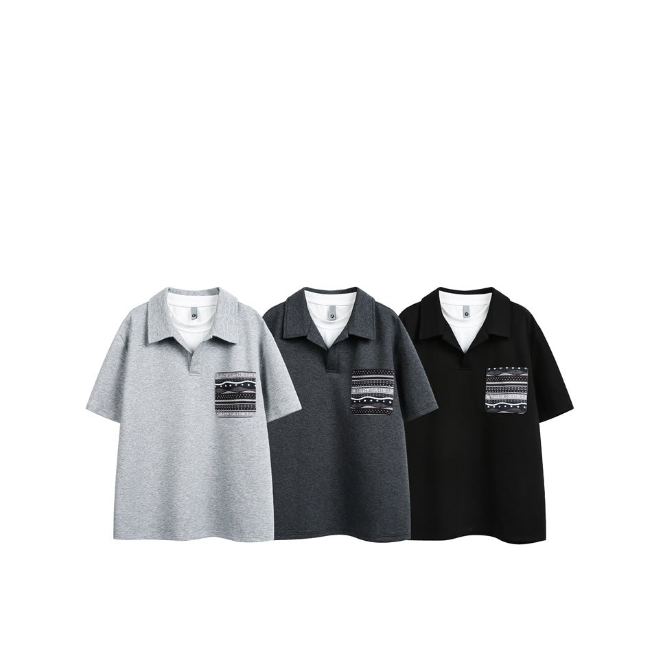 Three short-sleeve collared polos displayed together in light gray, charcoal, and black, each with a patterned chest pocket.