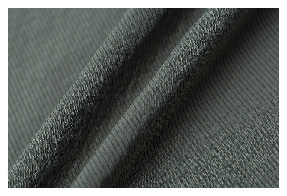 Close-up of gray fabric with a fine, narrow dark striped pattern and soft folds.