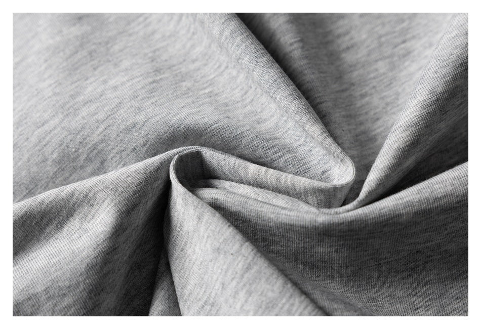 Close-up of heather gray knit fabric arranged in soft folds.