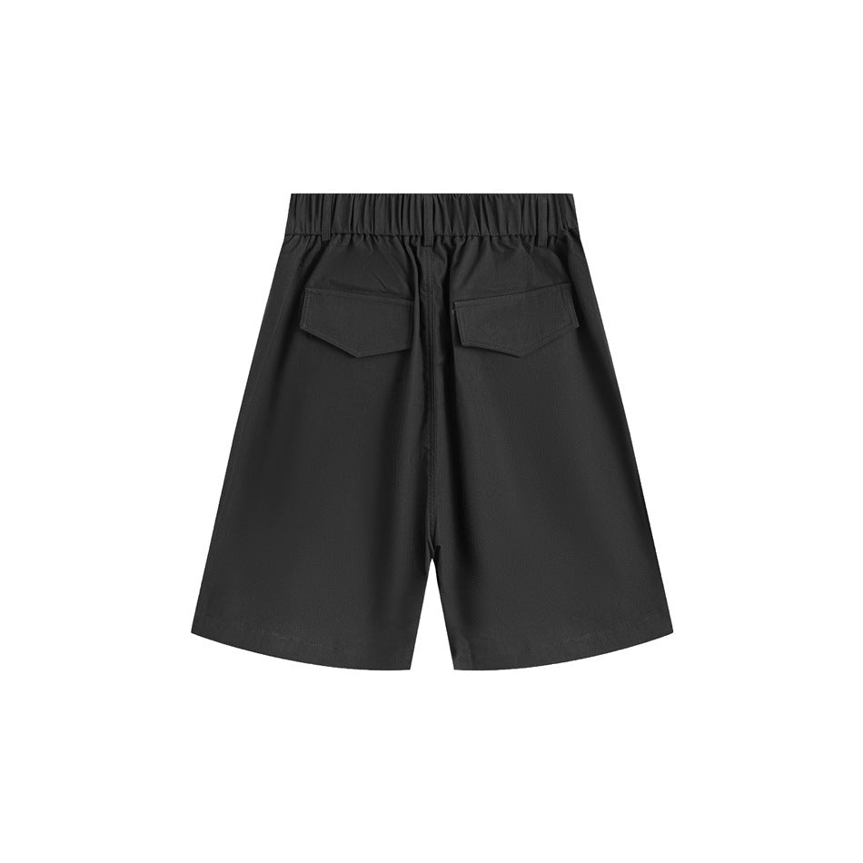 Back view of black wide-leg shorts with an elastic waistband and two flap pockets.