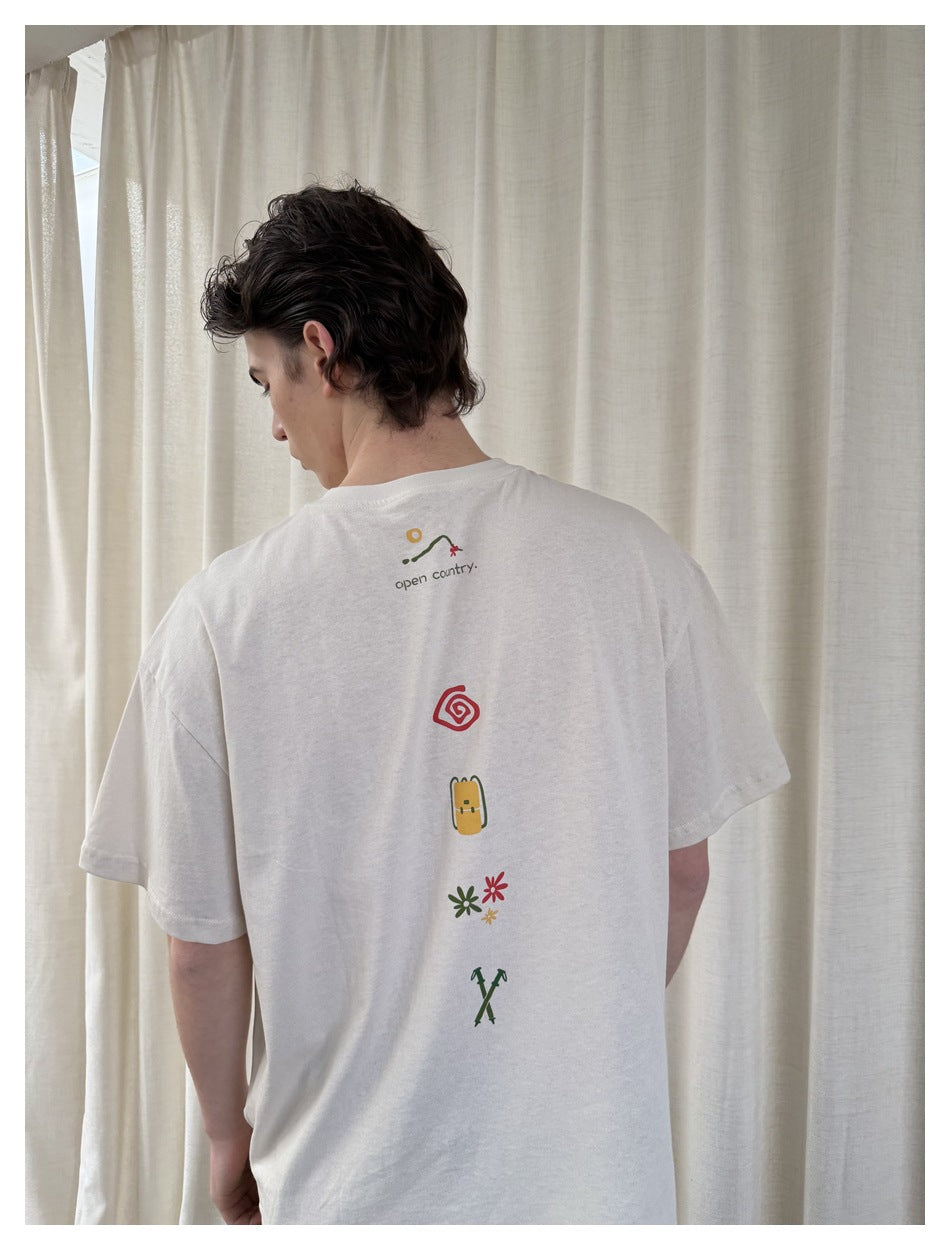 Back view of a person wearing an off-white T-shirt with a vertical row of small colorful graphics.