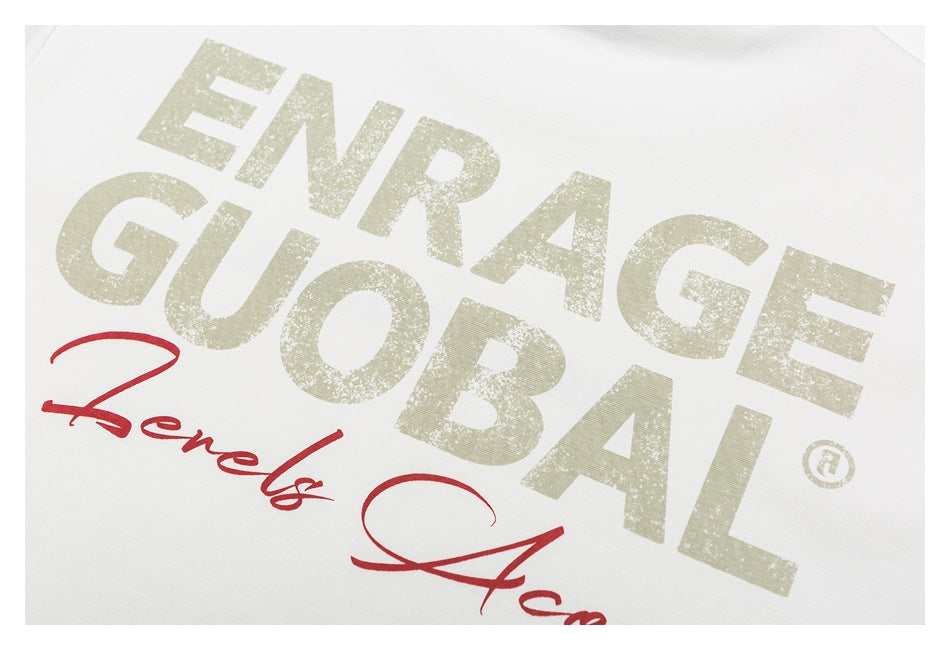 Close-up of the shirt's distressed pale “ENRAGE GLOBAL” print with red script beneath.