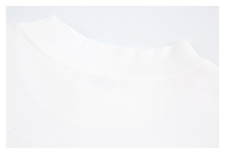 Close-up of a plain white T-shirt's ribbed crew neckline and upper chest.