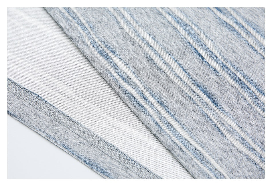 Close-up of gray, blue, and white striped knit fabric showing the inside and an overlocked seam.
