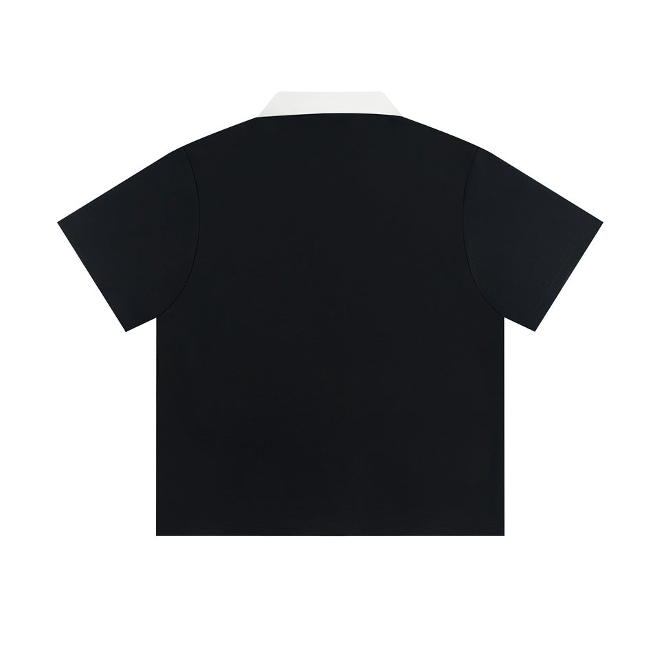 Back view of a black short-sleeve polo shirt with white collar, plain with no graphics, flat lay