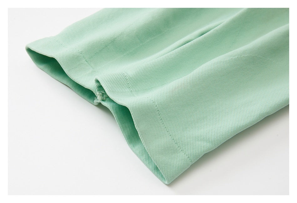 Close-up of the mint-green leggings’ stitched hem and folded fabric.