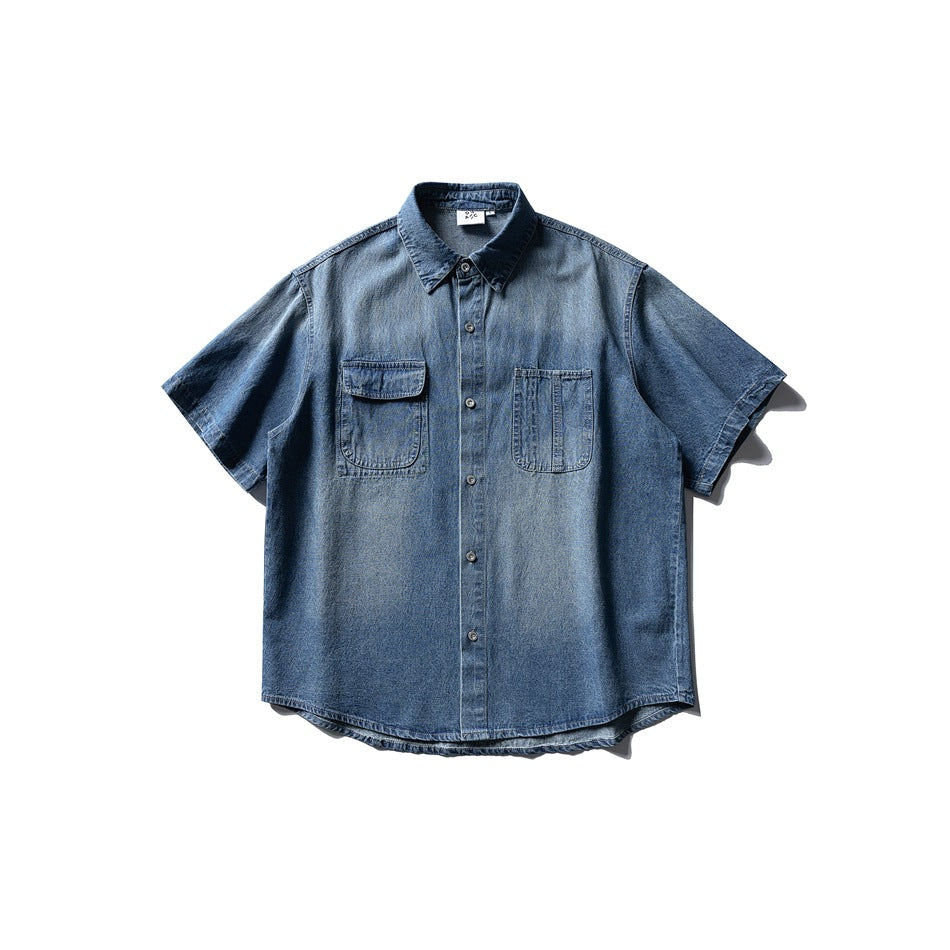 Faded blue denim short-sleeve button-up shirt, flat lay front view, with two chest pockets and a pointed collar
