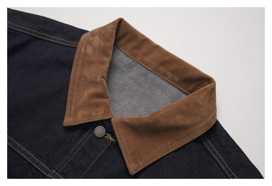 Close-up of a dark indigo jacket's broad brown collar, striped underside, contrast stitching and metal button.